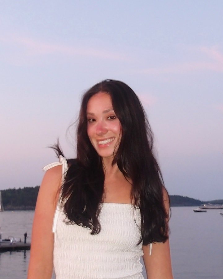 Annabell Borda, founder of Borda Design, smiling at a harbor at sunset